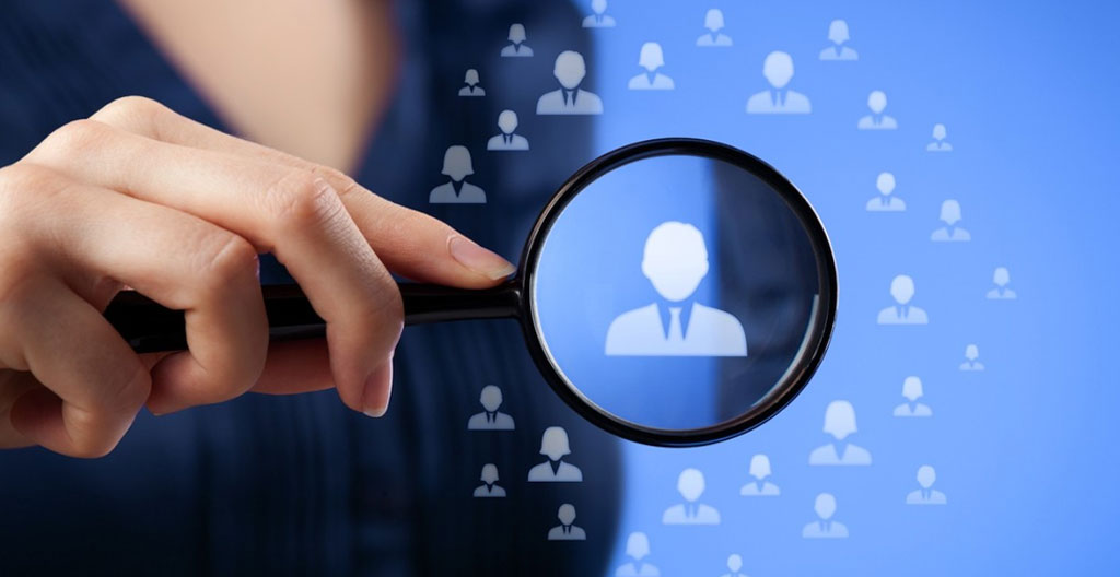 Recruitment consultant's hands preparing anonymized candidate profile, redacting personal identifying information while preserving professional qualifications for confidential submission to hiring company
